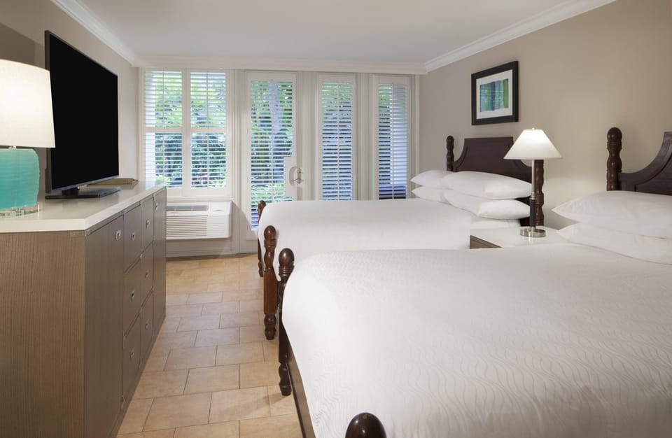 Stretch out in crisp linens in a bright double-queen room.