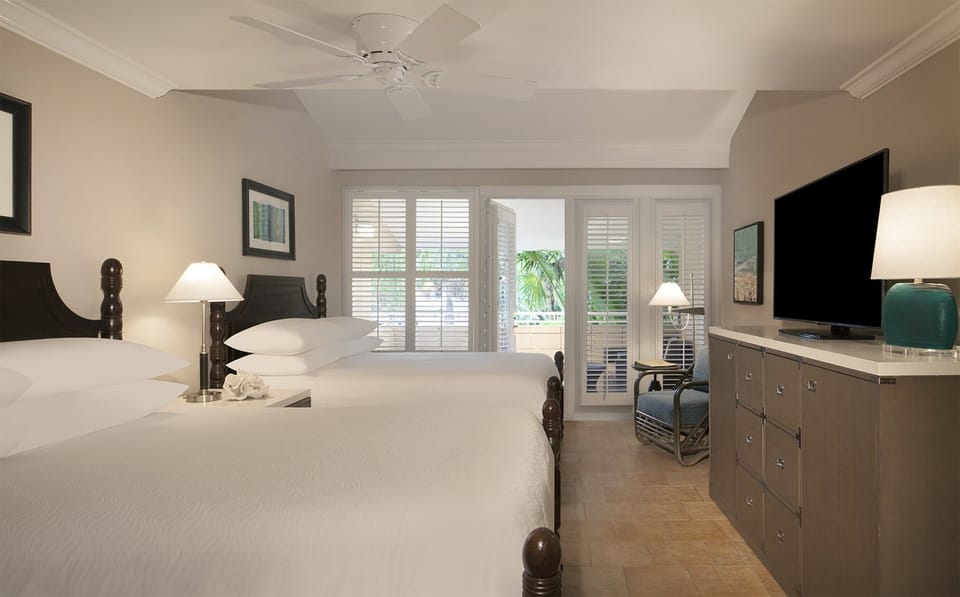 Relax in a spacious bedroom with balcony breezes and comfort.