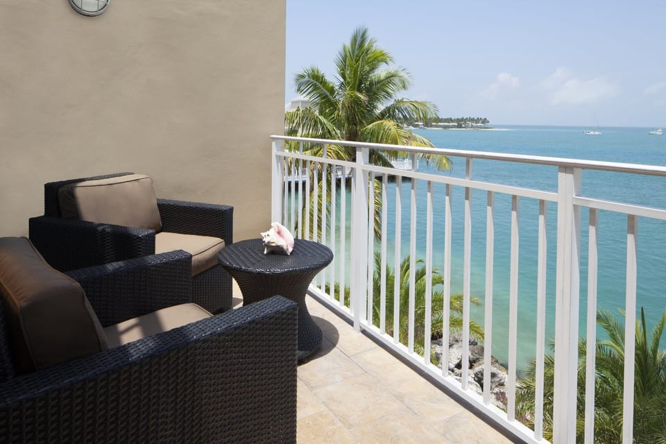 Sip morning coffee on the balcony overlooking turquoise water.
