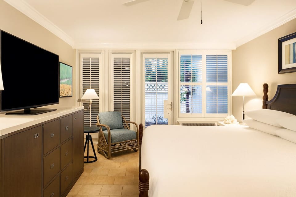 Drift off in a serene bedroom with soft lighting and shutters.