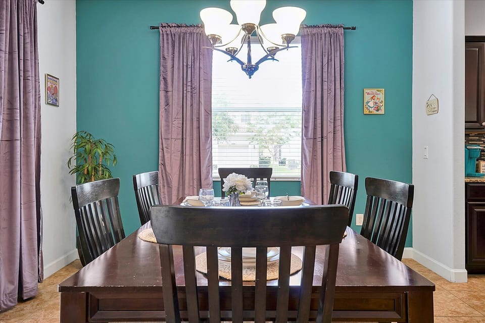 the dining room has windows with curtains