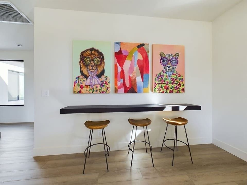 (2nd Floor) Secondary living space with multiple seating, smart TV, shuffle board, tic tac toe, and access to the balcony.
