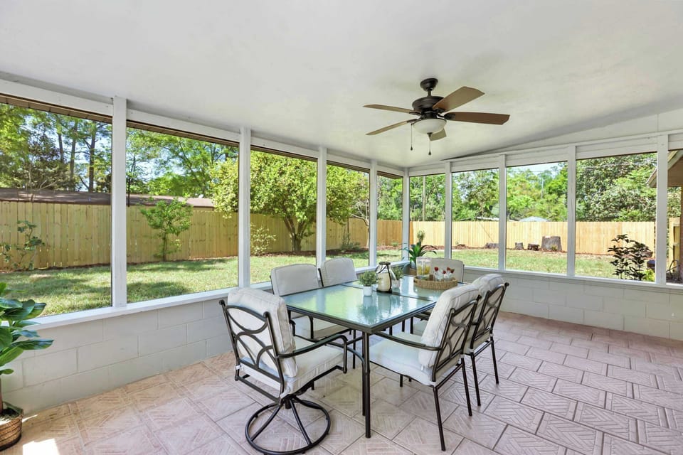 Discover the inviting exterior of our fully remodeled brick home, featuring a large screened porch and spacious backyard.