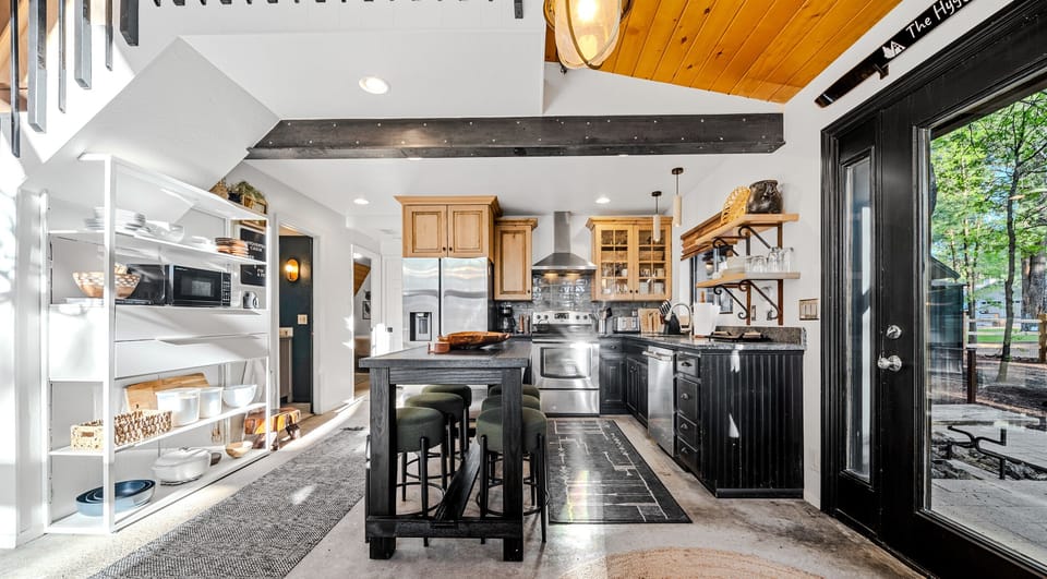 Fully stocked kitchen with island seating — cook, connect, and share meals together.