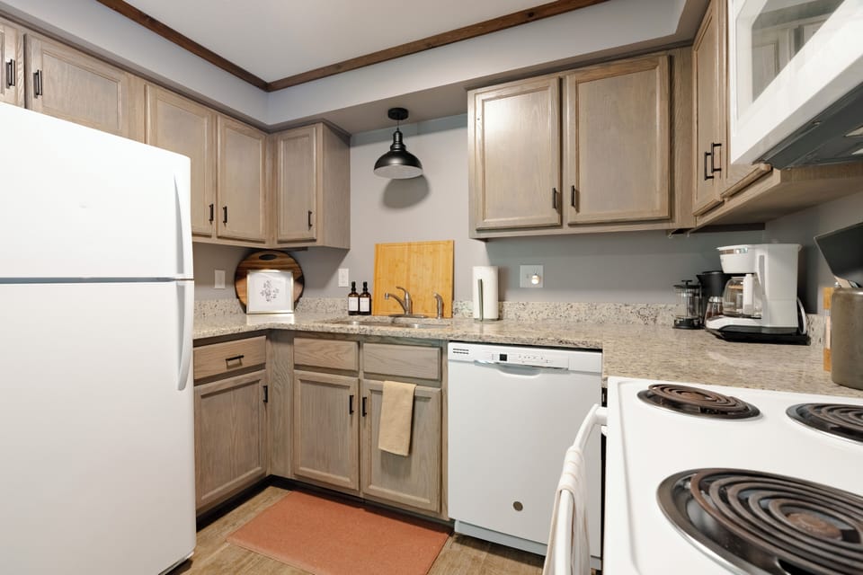 Kitchen is fully equipped with all the pots, pans, and utensils needed