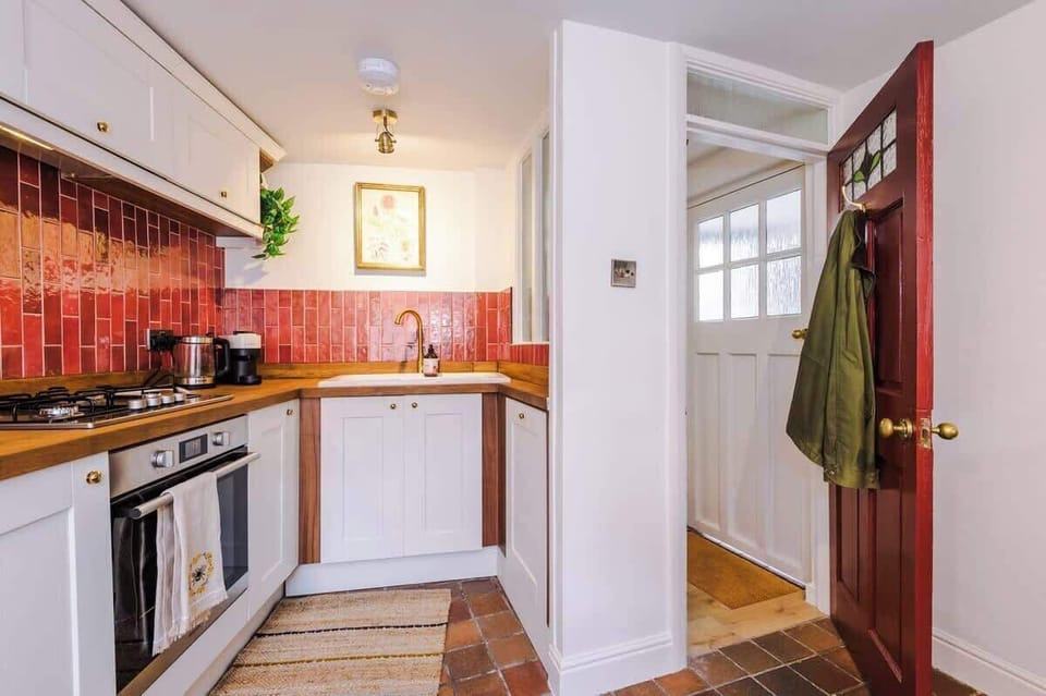 Gas hob with large sink and stocked cabinets. 