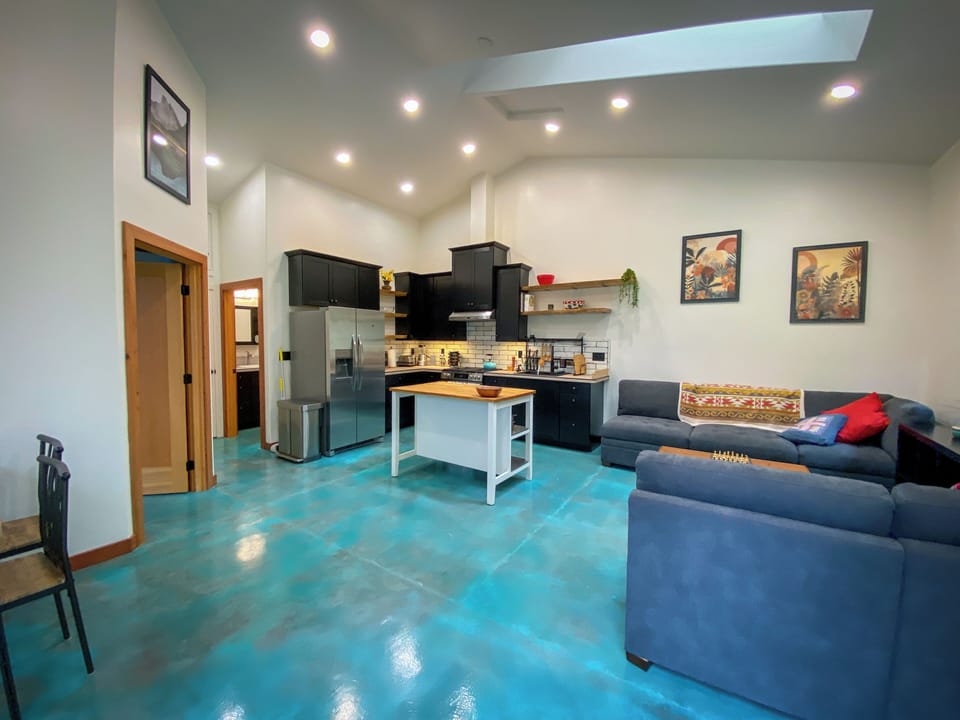 Very tall, vaulted ceiling and skylight makes space feel very large. 