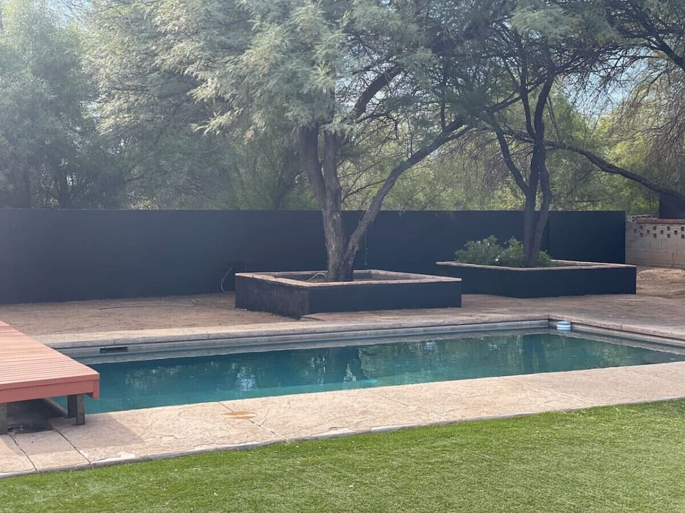 Spacious backyard with large pool (not heated) and mature trees backs up to a wash for added privacy