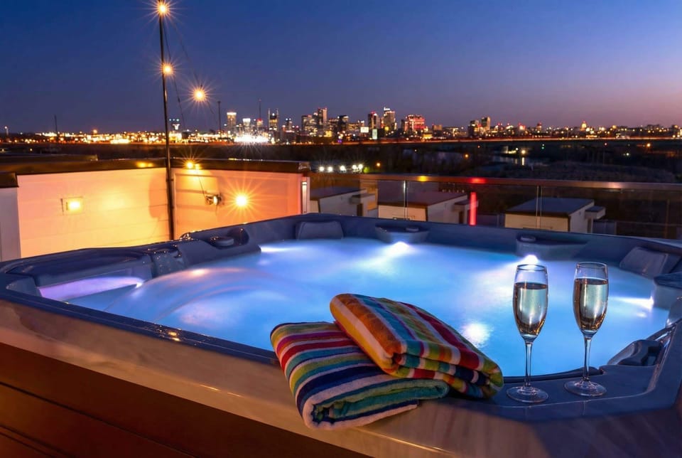 Two champagne glasses and a city skyline at dusk: this is the hot tub moment everyone's been waiting for all weekend