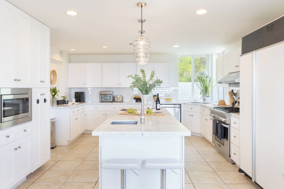 The kitchen includes an island and stainless steel appliances.