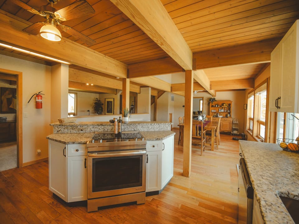 Spacious kitchen with modern appliances and warm wood finishes.