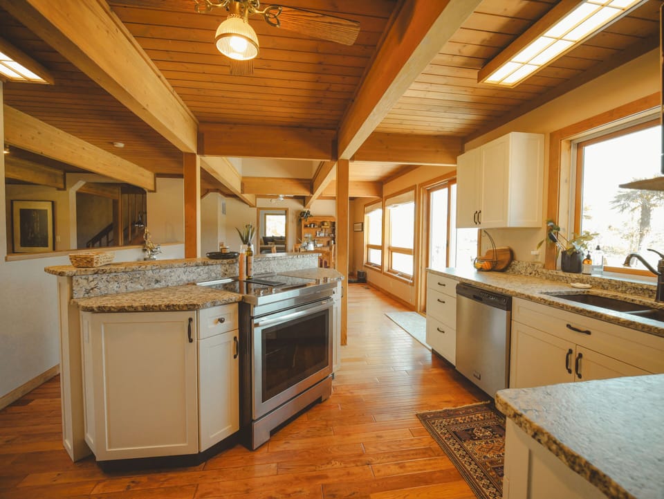 Spacious kitchen with modern appliances and warm wood finishes.