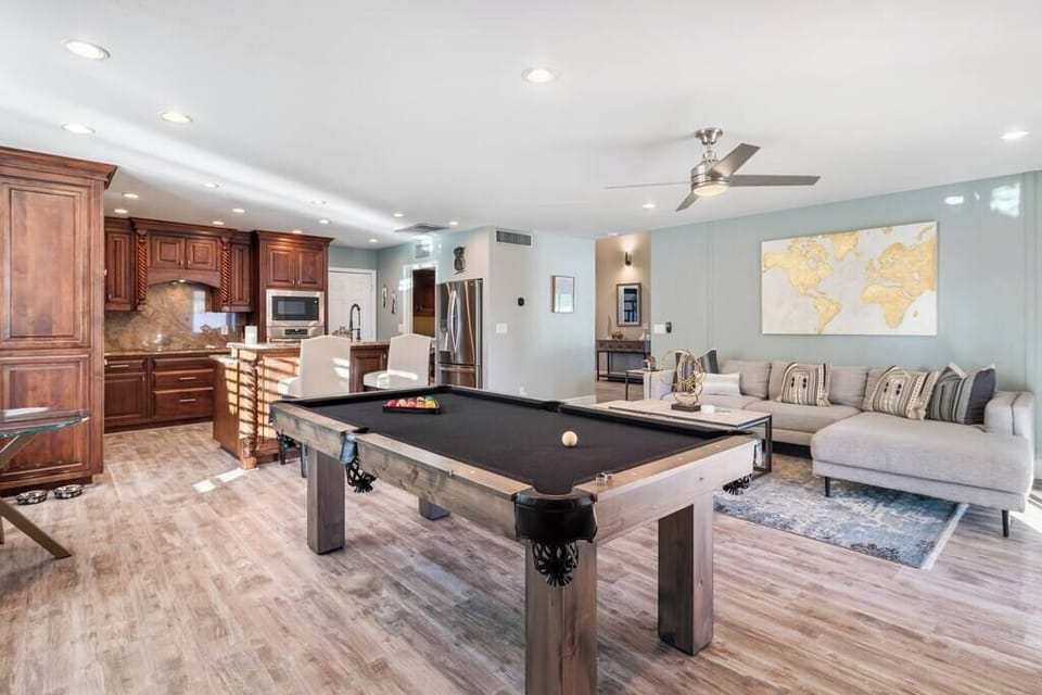 Pool table plus a TV and backyard views.