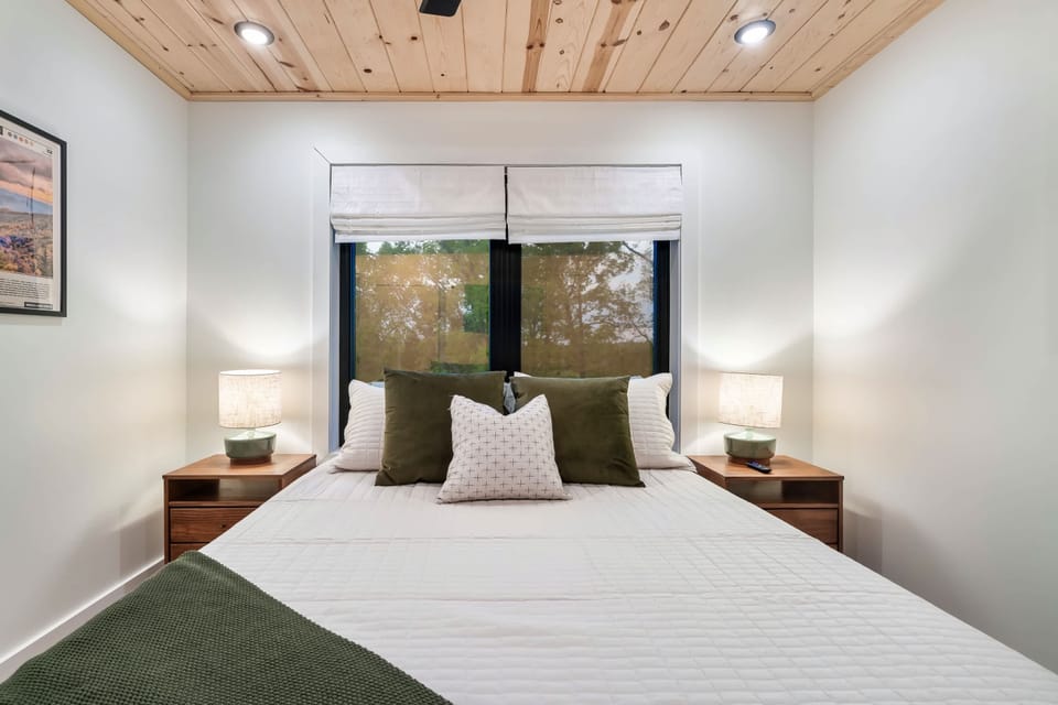 Upstairs in the second bedroom enjoy privacy and relaxation in the queen size bed