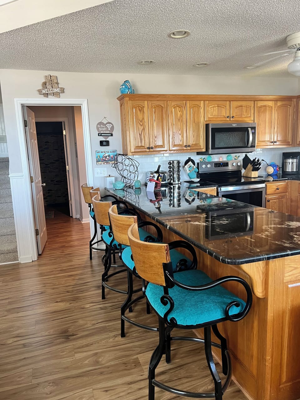 Kitchen and Island with high back swivel stools. 