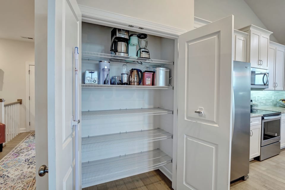 Pantry stocked with kitchen appliances & supplies