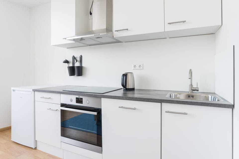 Fully equipped kitchen with modern appliances and clean design.