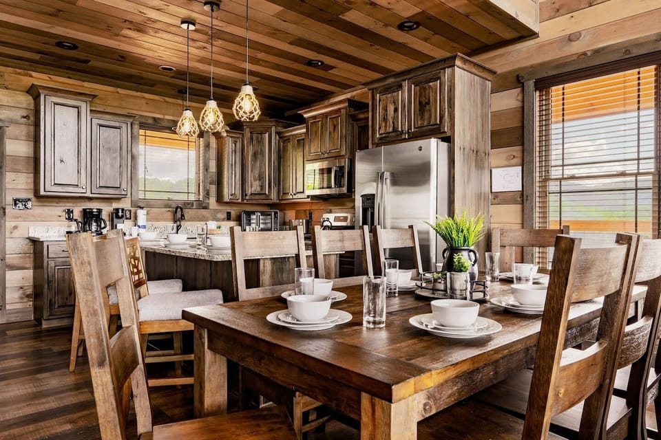 Our 8-persons dining table with our kitchen beyond.  Bear Mountain Vista cabin.