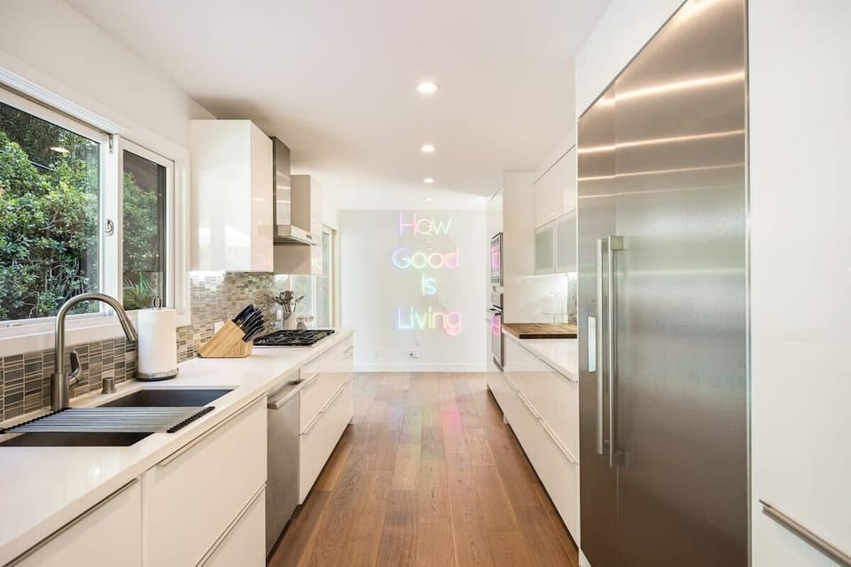 The sleek kitchen boasts top-of-the-line appliances and ample counter space.