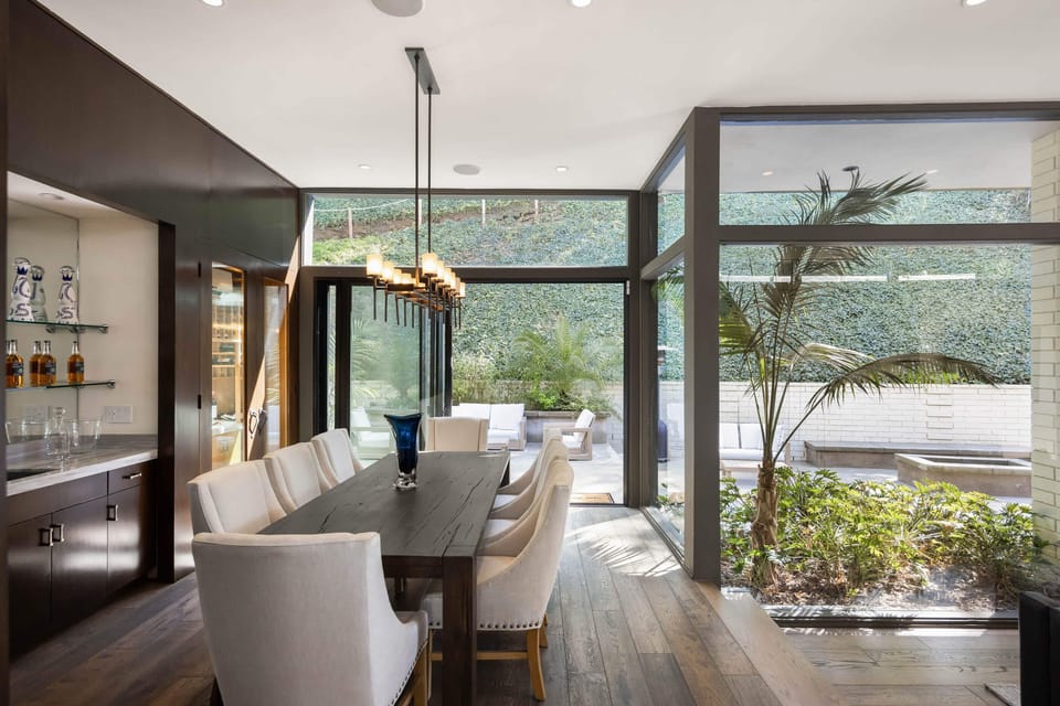 Indulge in gourmet delights in the dining room, equipped with sleek countertops and elegant seating.