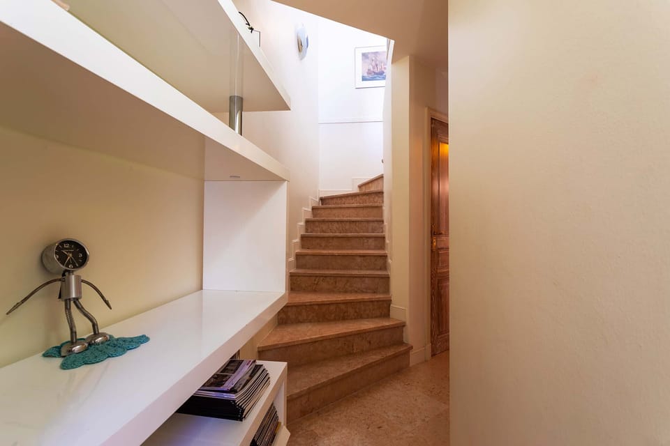 A functional staircase connects the bright living room to the master bedroom, providing a smooth and natural transition