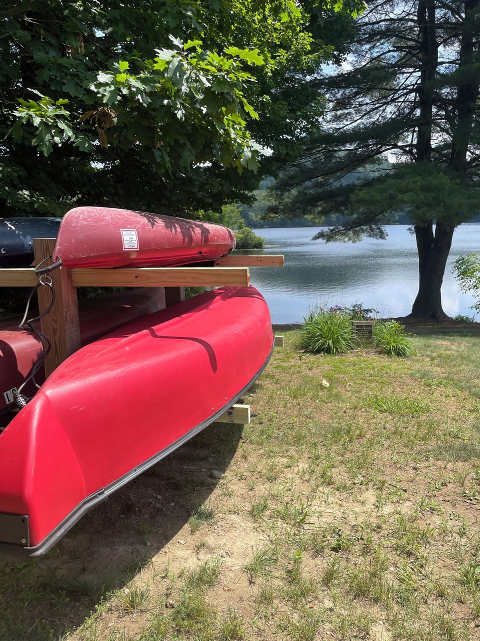 Canoe and kayak ready to launch at the beach and awaiting guests.