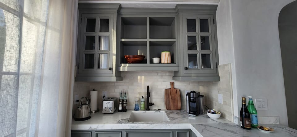 Marble kitchenette with nespresso, microwave, induction cooktop and wine fridge