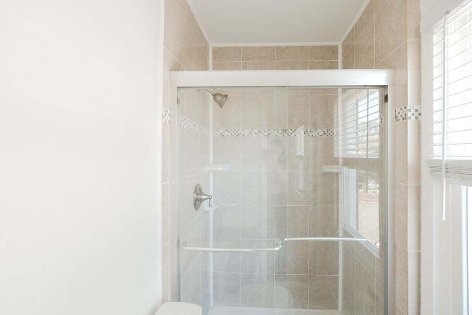 Clean & Modern Full Bathroom with Essentials. Includes shampoo, conditioner, body wash, and fresh towels.