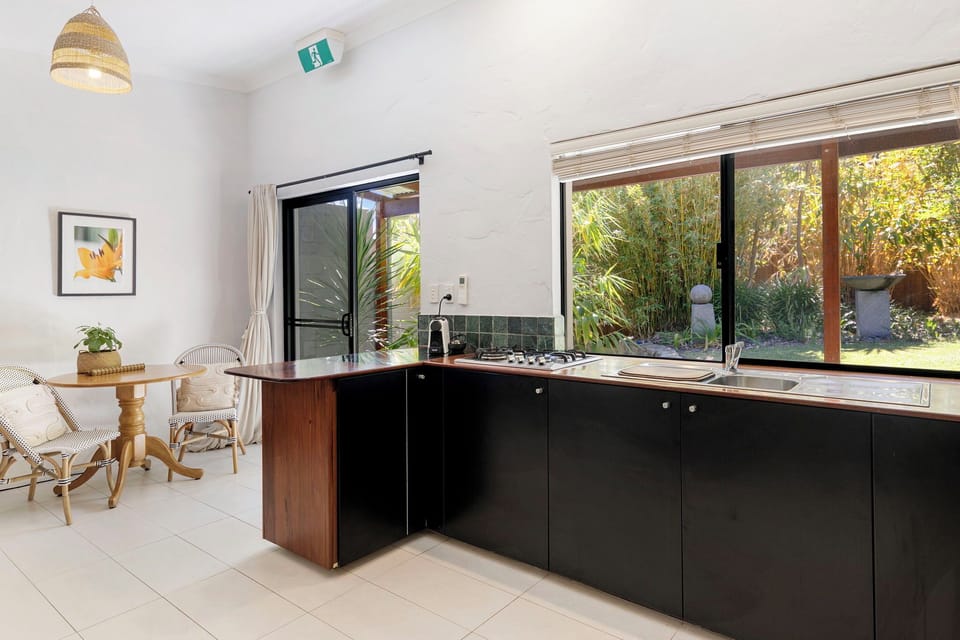 Open kitchen/dining with tranquil garden outlook. 