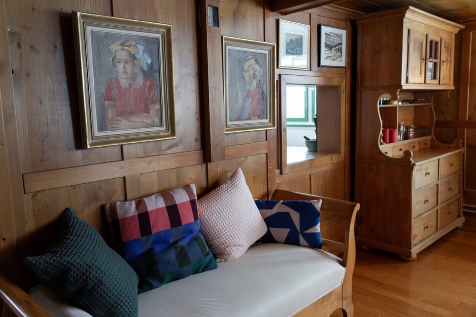 Cozy seating area with cushions, artwork and wooden interior