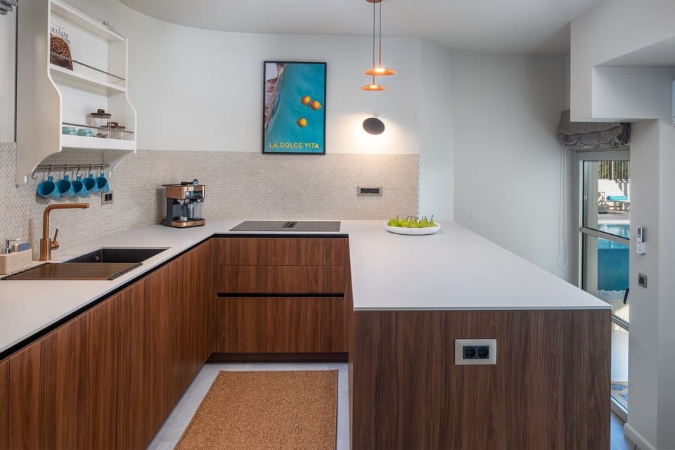 The modern kitchen is fully equipped with all the necessary amenities and appliances for a pleasant stay