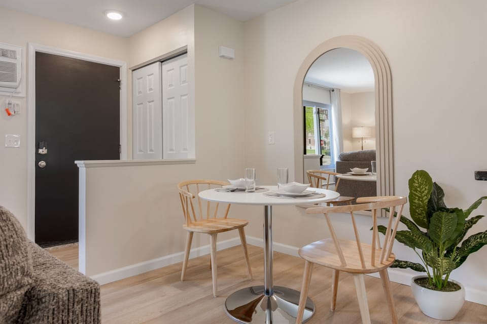 Charming dining nook with an arched doorway, providing a seamless transition to a cozy living area—perfect for intimate meals and conversations.