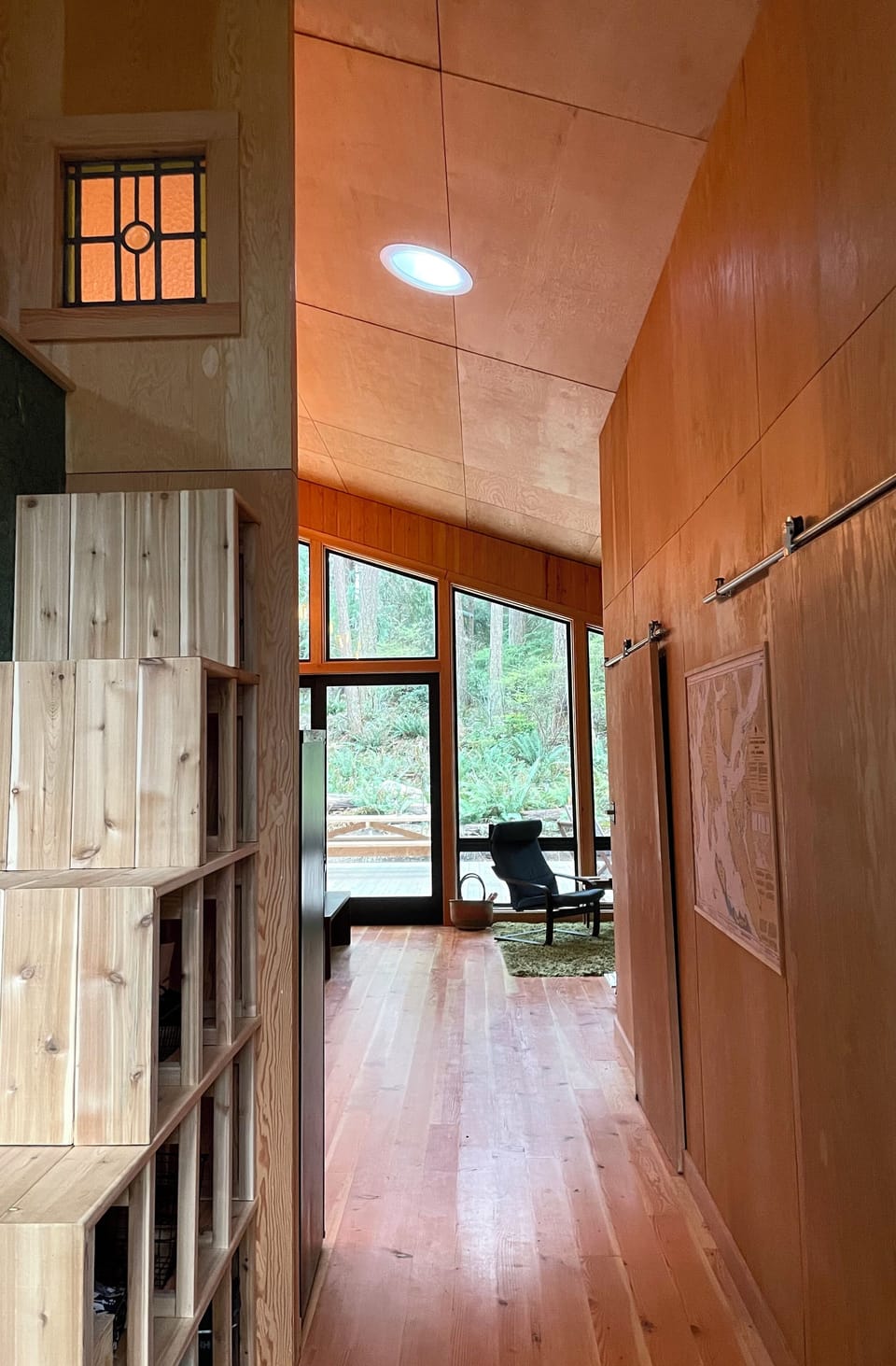 Hallway into cabing with bedrooms on the right, storage on the left