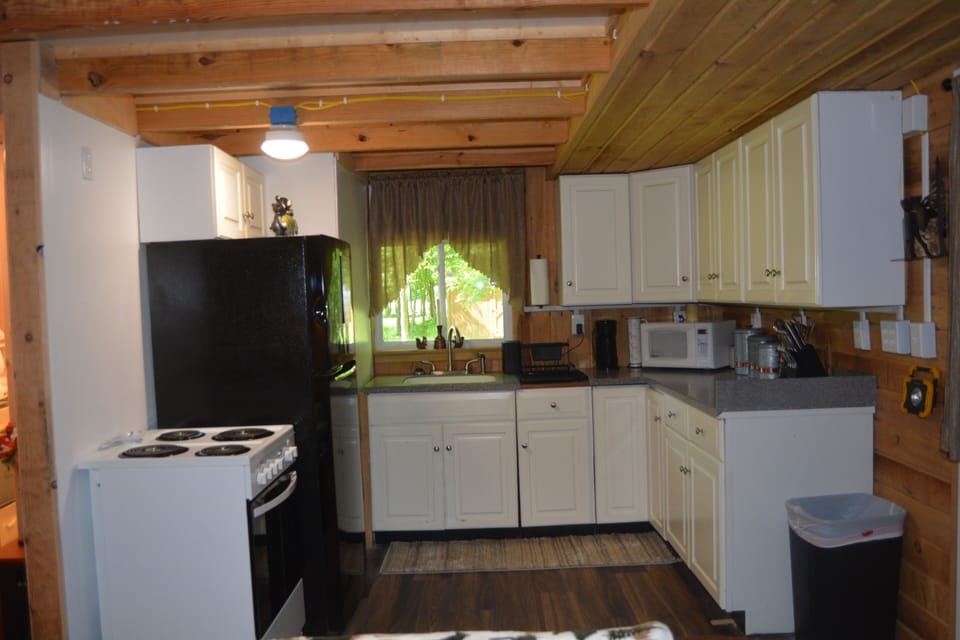 Fully equipped kitchen.  Stove, fridge, microwave, hot & cold running water