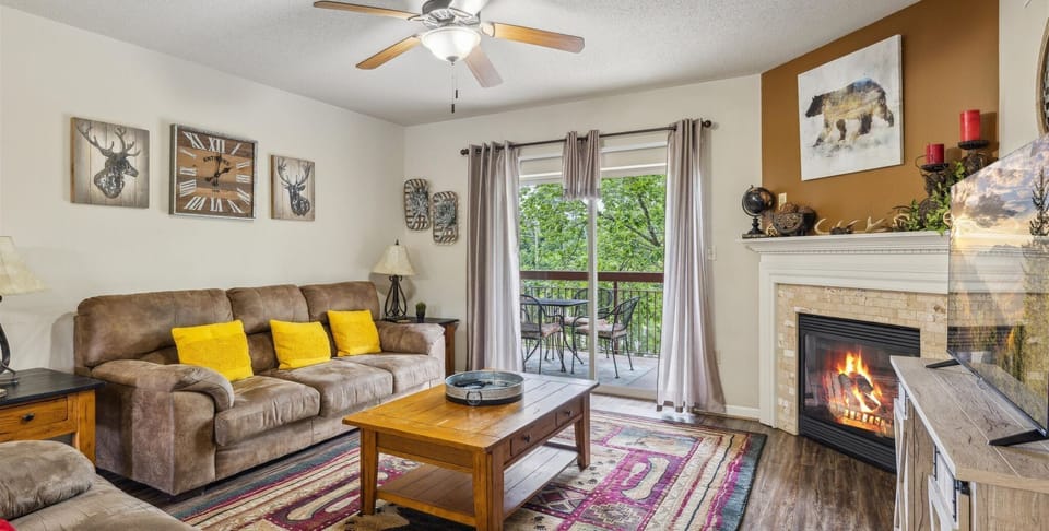 Two Bedroom Condo Pigeon Forge Sleeps 6 on the River Cedar Lodge - Spacious Living Room with Gas Fireplace, Sleeper Sofa and SMART TV with Cable & WIFI throughout vacation rental