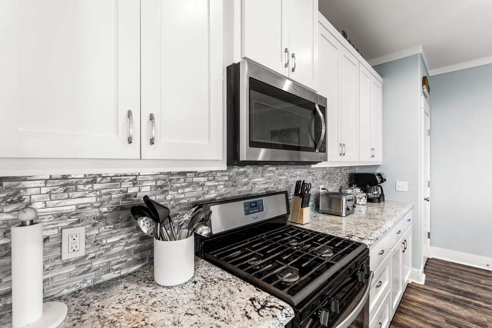 Gas cooktop and oven; microwave; large toaster; coffee maker and coffee supplies