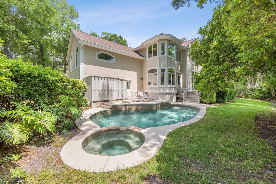 The highlight of this home is its private yard. At its heart lies a pool and splash-down spa, perfect for unwinding or fun water activities.