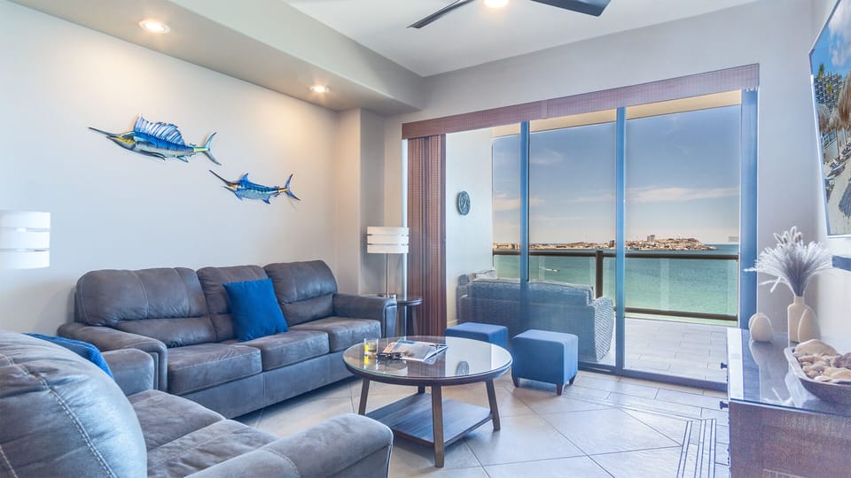 The living room with its sofas and balcony access.