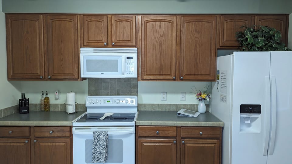 Fully stocked kitchen with stovetop and oven, microwave and small appliances