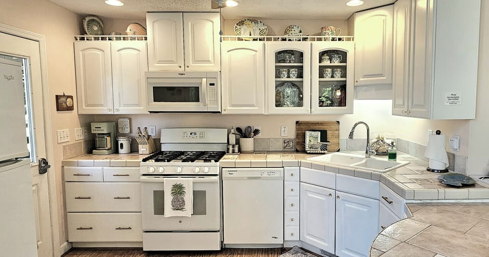 Fully stocked kitchen with gas stove/oven, microwave, dishwasher & refrigerator.