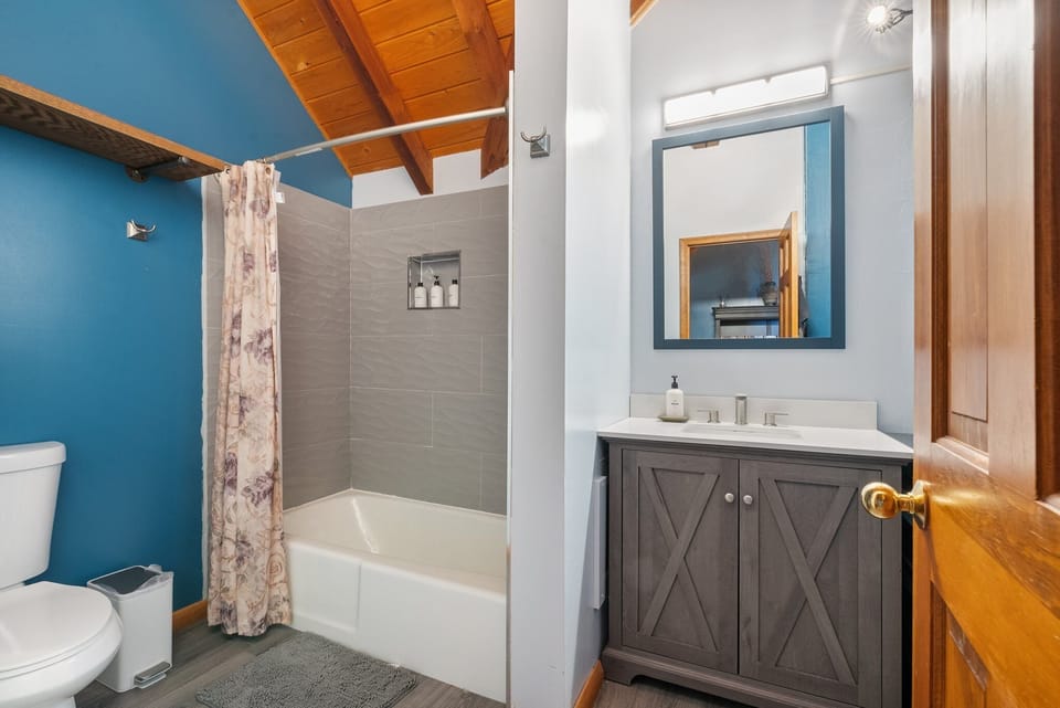 Bathroom 1: full bathroom with bathtub/shower combo; shared by bedrooms 1 and 2