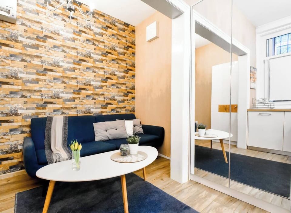 Enjoy the fusion of cozy and contemporary in our living room, where a plush sofa and tasteful decor create a welcoming vibe for guests.