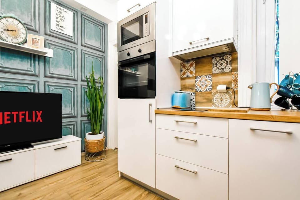 Craft your culinary delights in a kitchenette that combines chic design with functionality