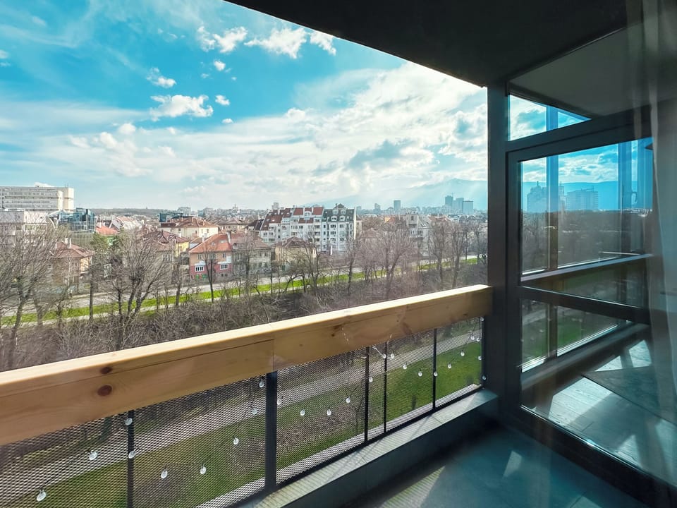 #SofiaSharedCharm
#CityscapeTerraceViews
#PastelRetreatSofia
#SharedLuxuryLiving
#CozyCommunalExperience