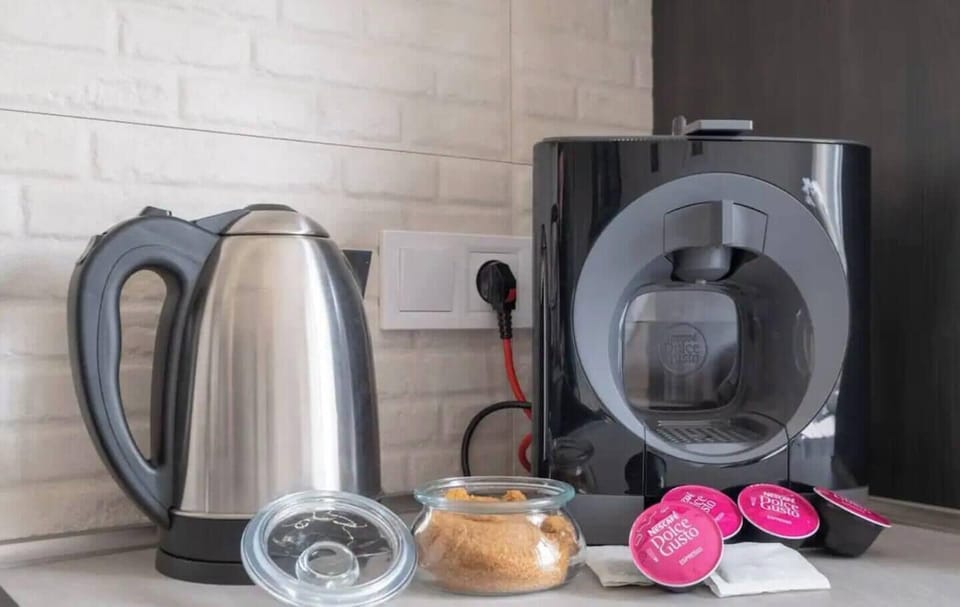 Start your morning right with a freshly brewed coffee from our modern coffee maker, accompanied by a fully stocked kitchen.