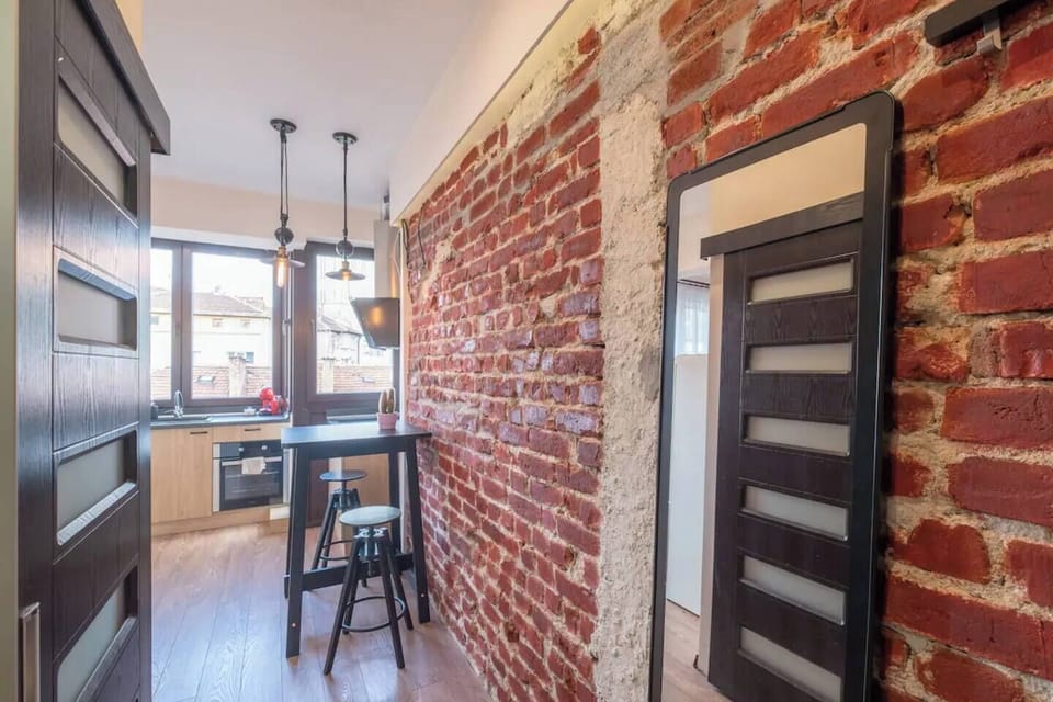 Charming Industrial-Inspired Living Space This unique living space combines exposed brick and industrial lighting with modern comforts. Relax in this stylish space after a long day exploring Sofia’s cultural gems. You’ll love the cozy yet trendy vibe that makes this studio feel like home. Don’t miss out on this stylish gem in Sofia – book now!