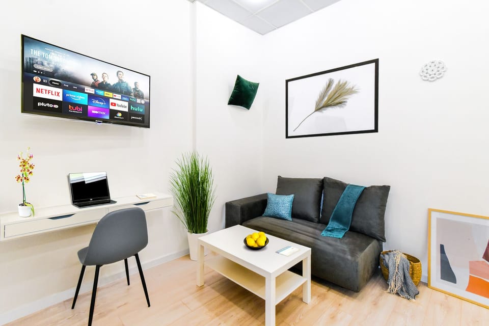 Step into the bright and cozy living room, where you can unwind on the comfortable sofa and enjoy your favorite shows on the flat-screen TV with multimedia options. Whether you’re watching Netflix or catching up on some work, this space offers the perfect blend of relaxation and functionality.
