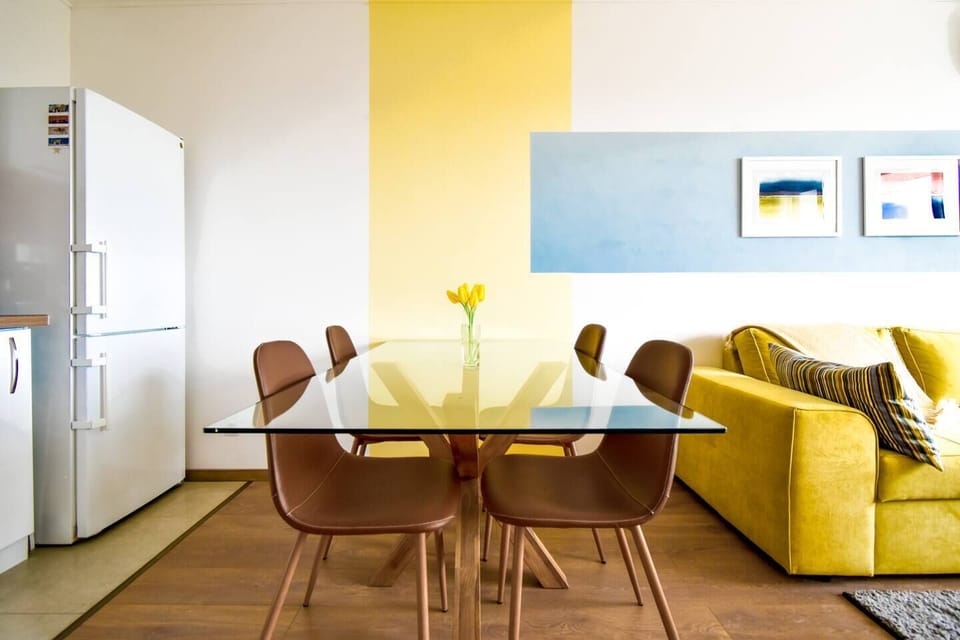 You’ll gather around this stylish dining area, perfect for sharing meals or planning your day. Enjoy your time together in this welcoming space.