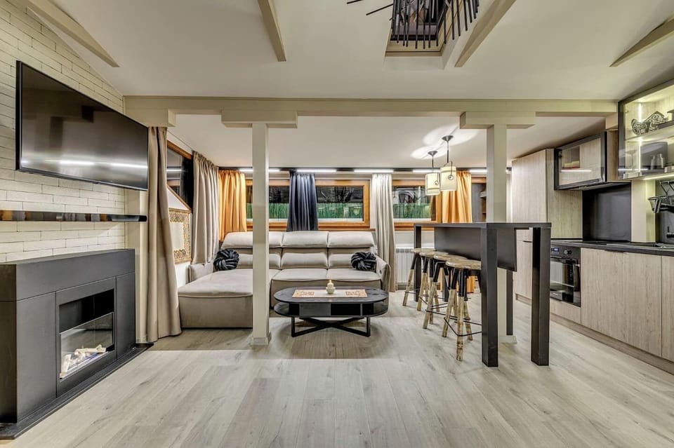Get cozy in this modern, open-plan living room. Perfect for evenings by the fire or movie nights! 🔥 Book Your Stay Today!