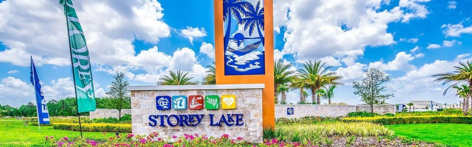 Welcome to Stoney Lake, a vibrant community with bright signage and lush landscaping that creates a sunny atmosphere. Colorful flags flutter in the breeze, inviting you to discover the charm this destination has to offer.